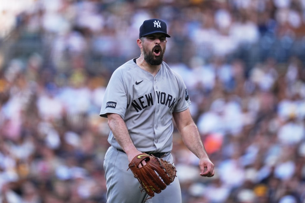 New York Yankees pitcher Carlos Rodón yells after the last out in a game against the San Diego Padres.