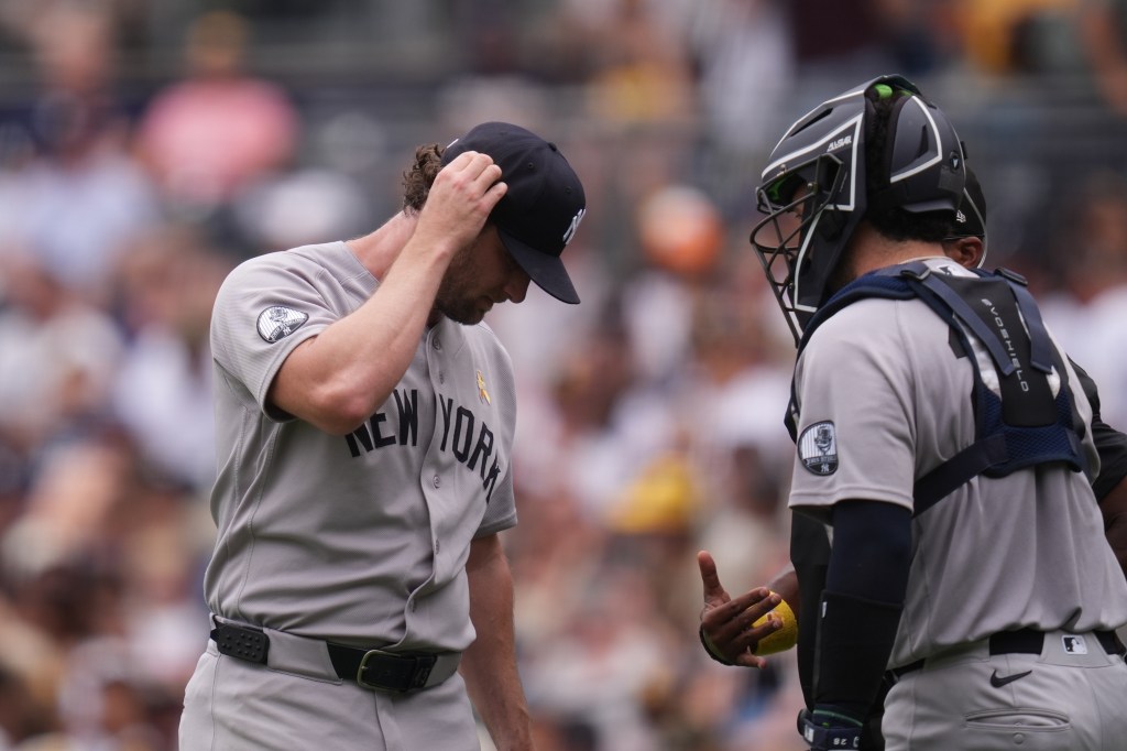 Gerrit Cole talks with Austin Wells after giving up three home runs.