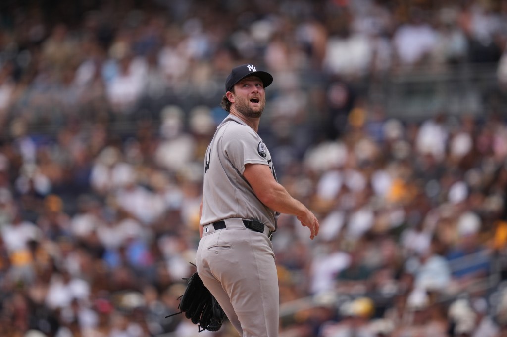 New York Yankees pitcher Gerrit Cole watches a home run during a baseball game.