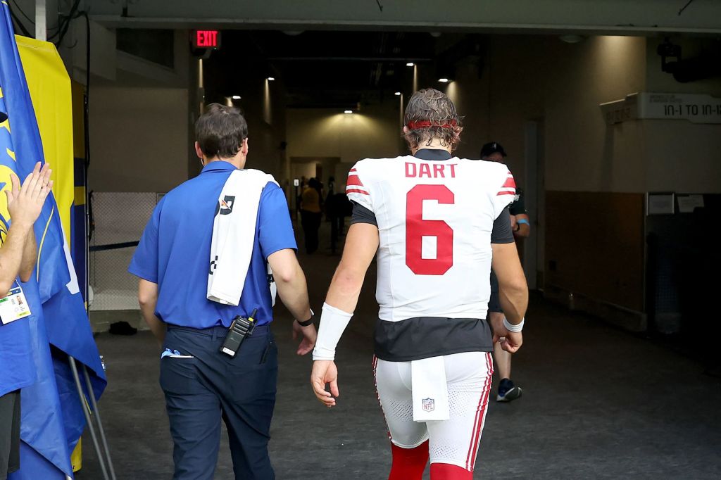 An image collage containing 1 images, Image 1 shows New York Giants quarterback Jaxson Dart (6) walks off the field with a staff member into the locker room