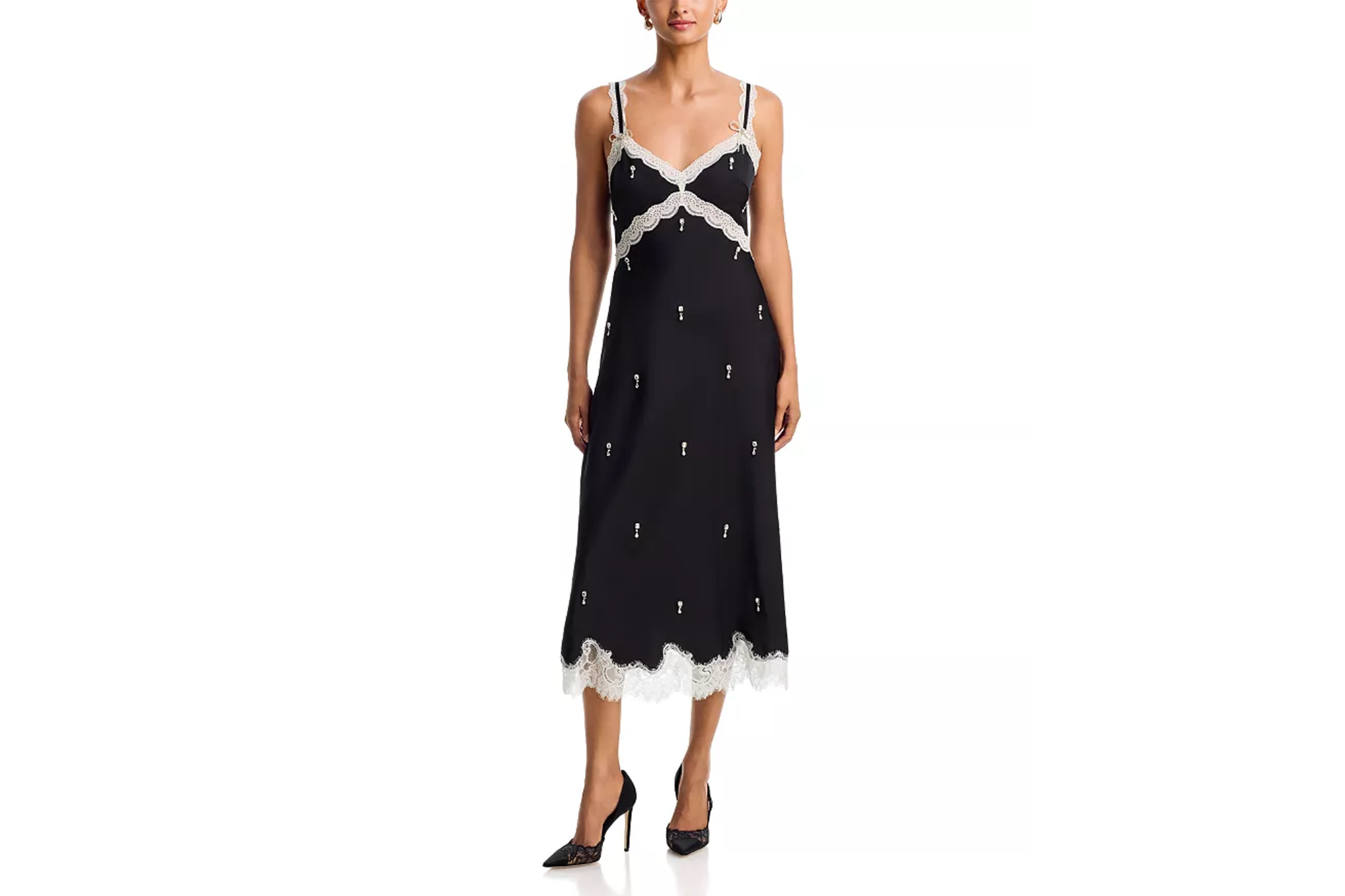 Nicky Hilton wearing a black lace-trimmed slip dress with white embellishments.