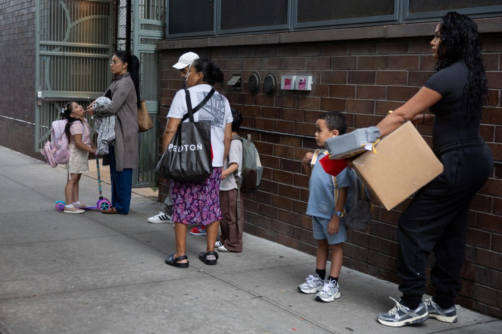 Parents and children waiting in line outside a school on the first day of New York City Public Schools.