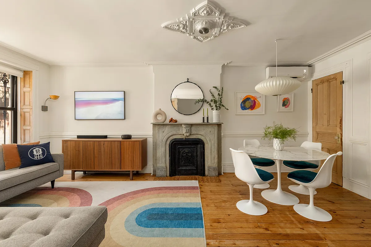 living room with mantel, wood floor