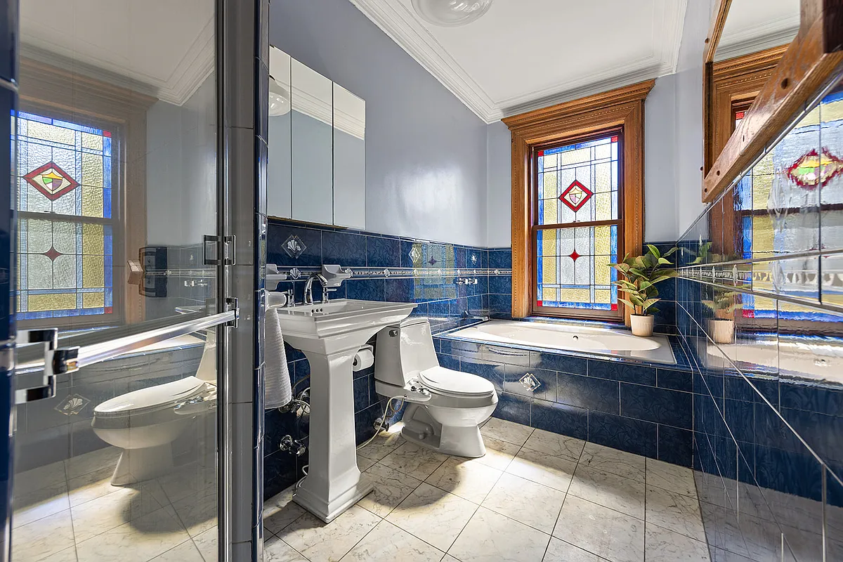 bath with stained glass window, blue wall tile