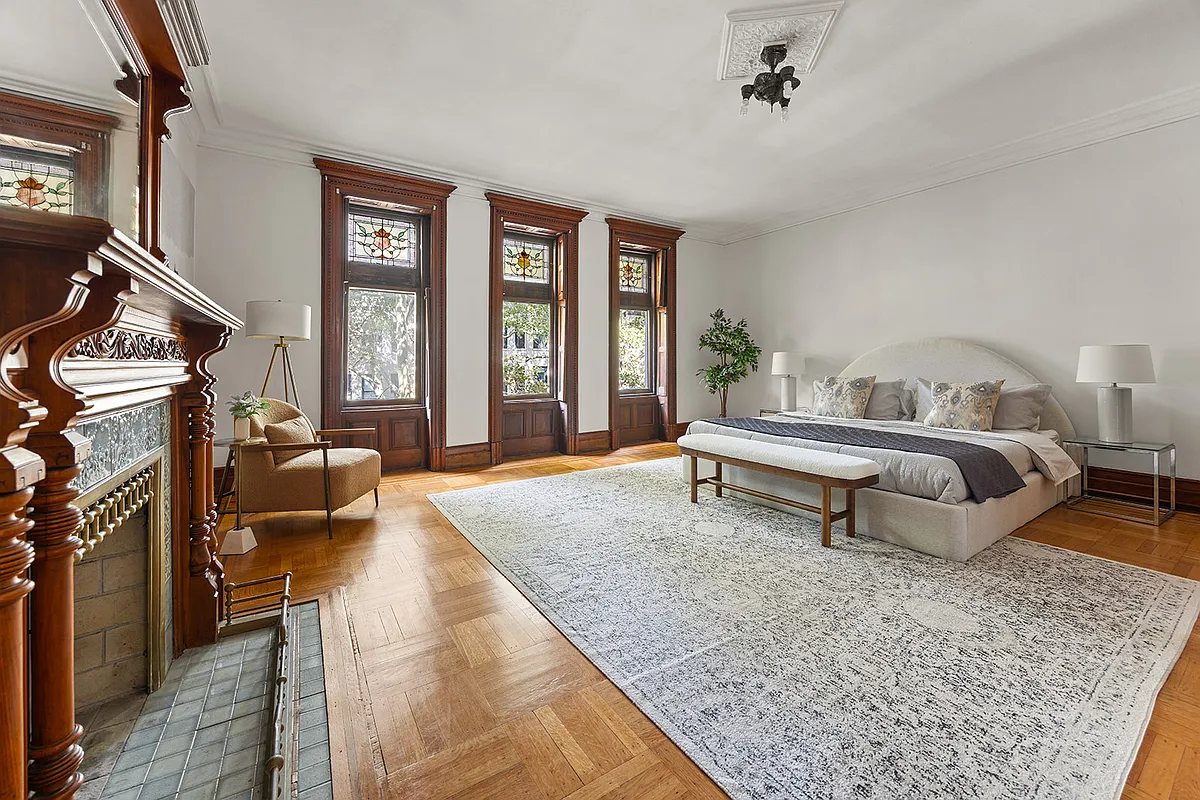 bedroom with mantel, wood floor, stained glass