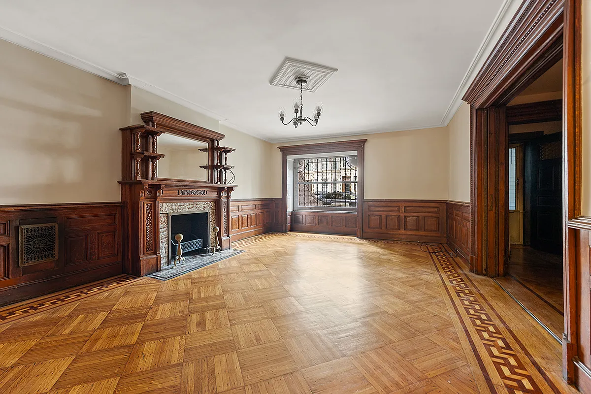 garden level original dining room with wainscoting, mantel, wood floor
