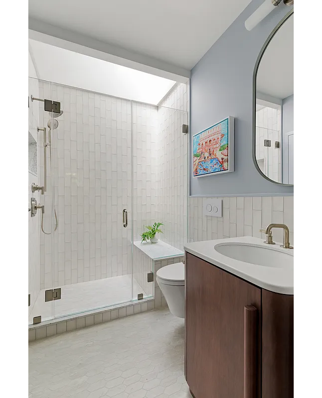 bathroom with walk-in shower with a bench