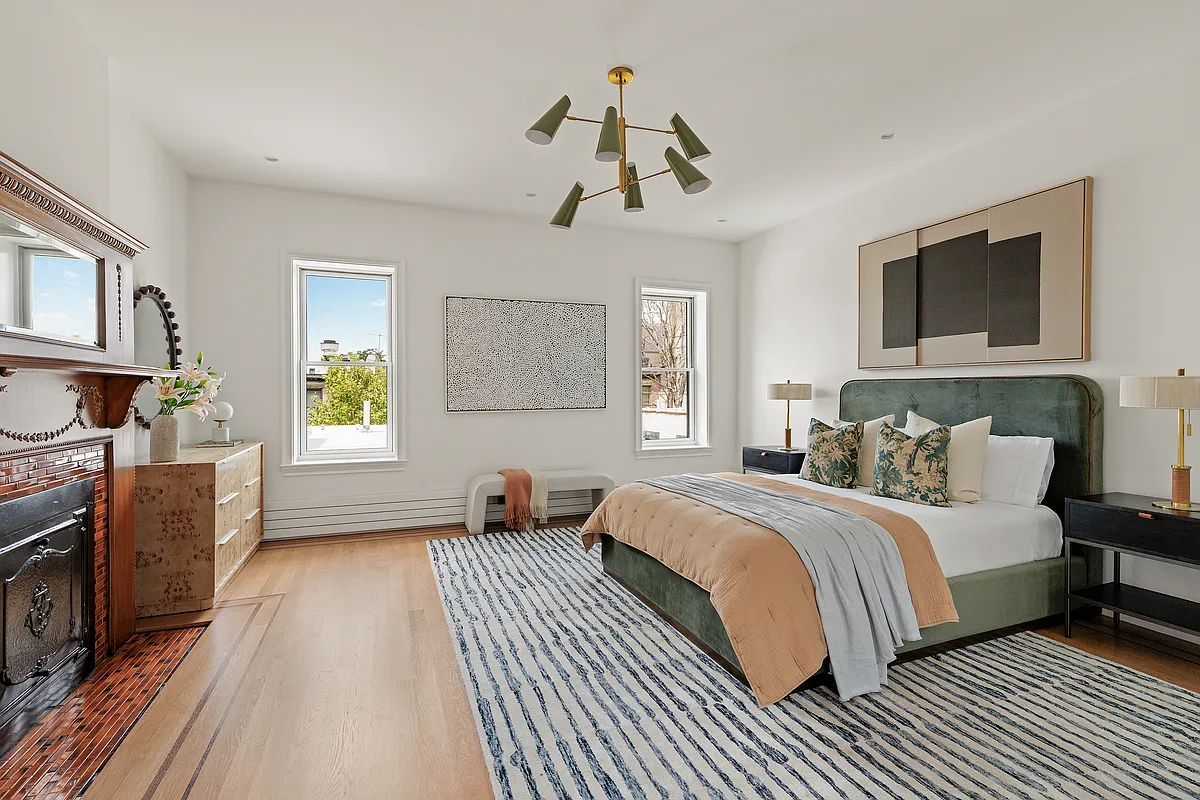 bedroom with wood floor, mantel with insert and tile surround