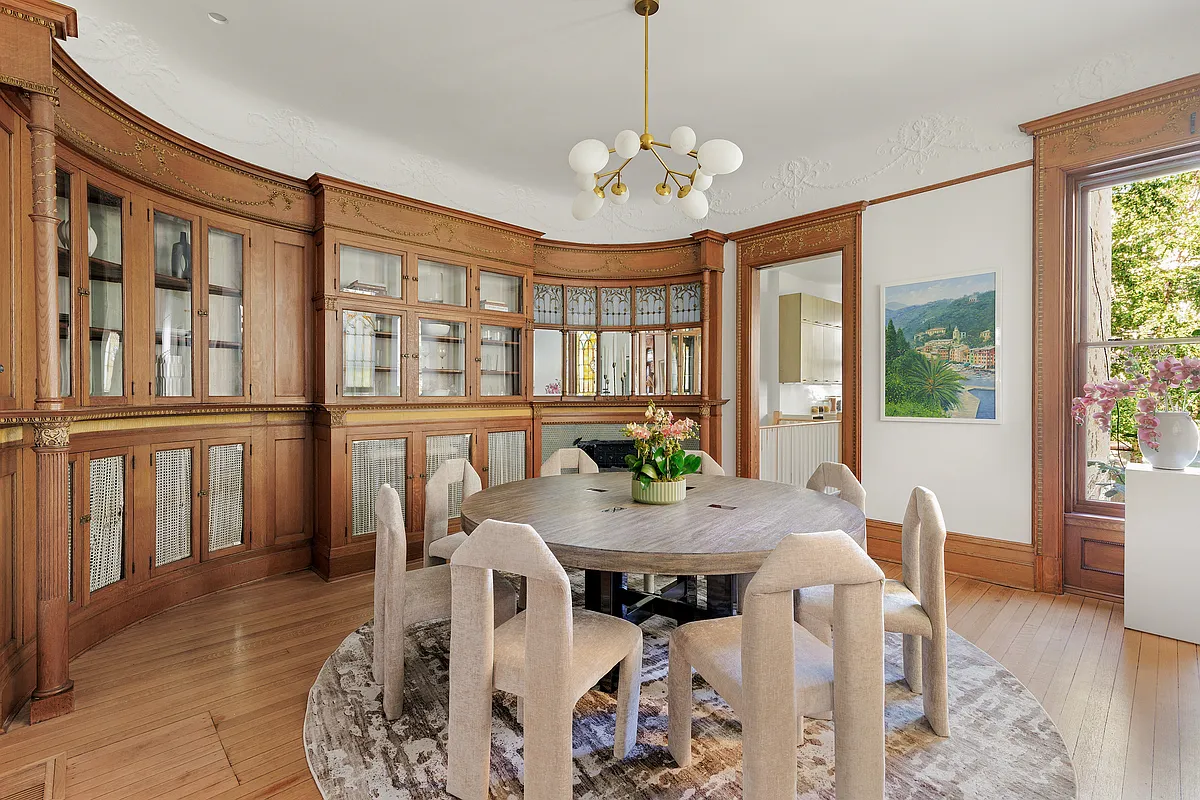 dining room with curved wall with built-in china cabinets