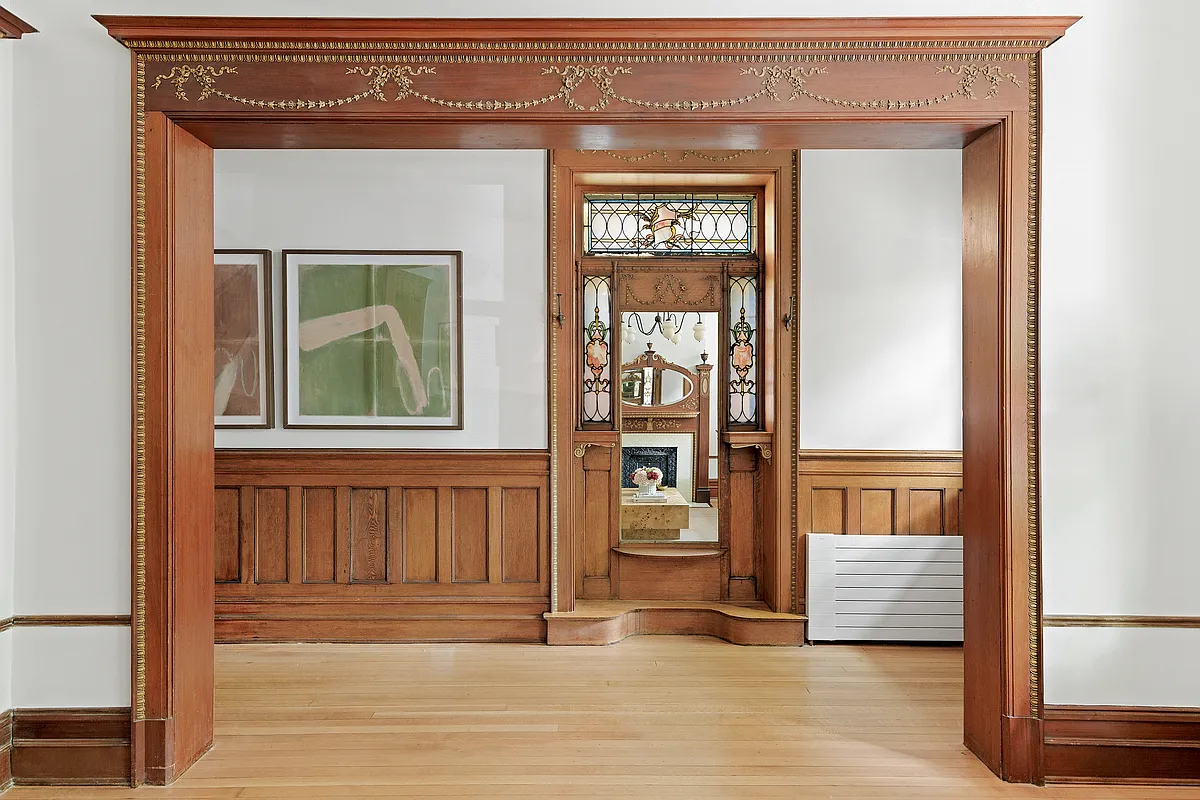 entry hall with wainscoting, stained glass