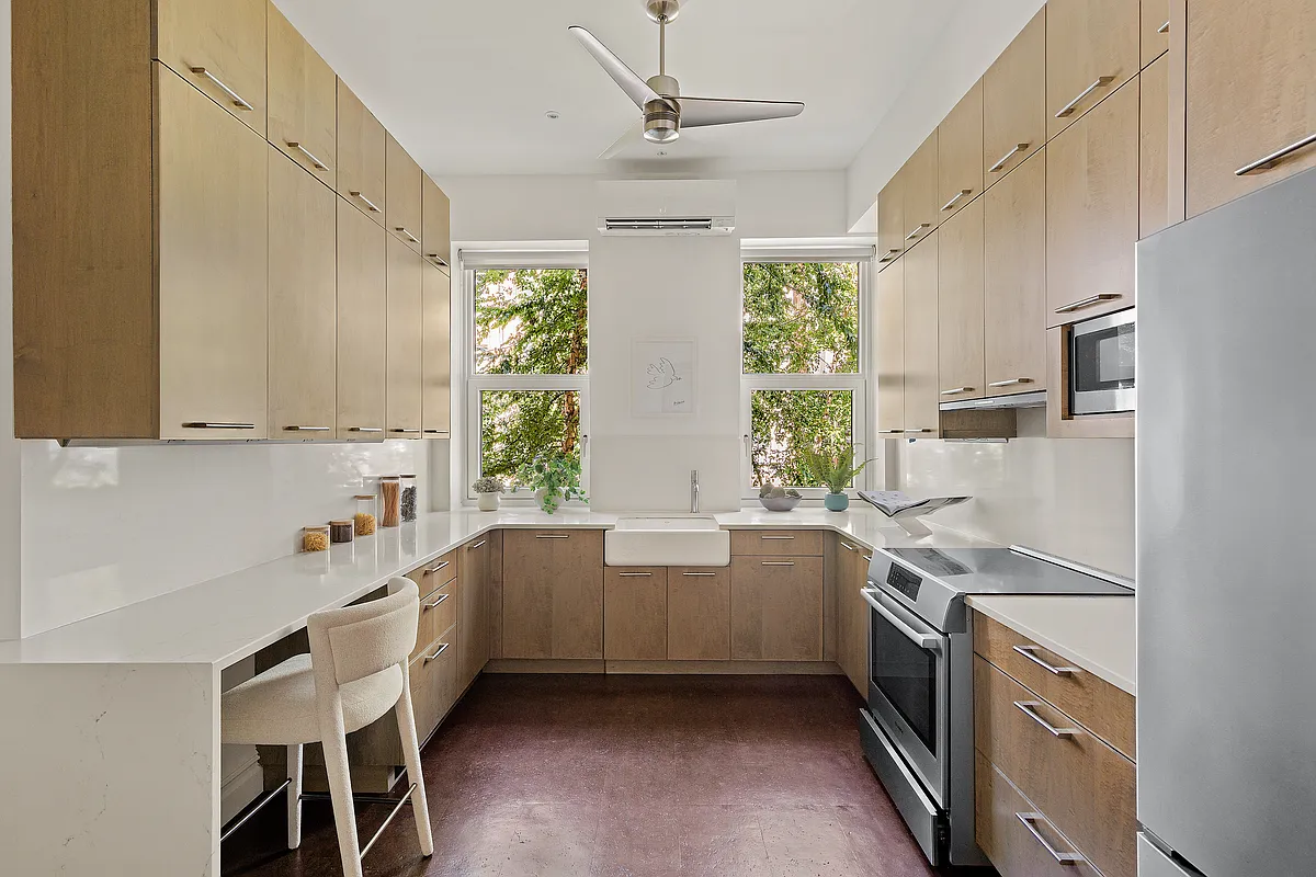 u shaped windowed kitchen with slab front cabinets
