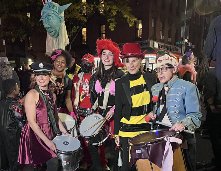 Costumed drummers and marchers at the Park Slope Halloween Parade at night