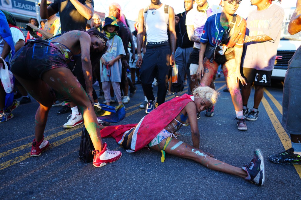 People covered in paint celebrating J'Ouvert in Brooklyn.