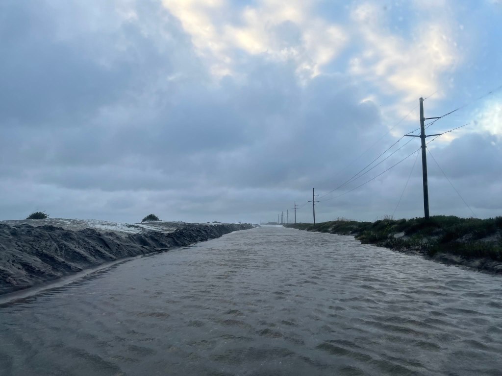 Pics from Pea Island this morning. The road is currently covered in 4' of water in some areas, as well as deep sand. At this point, it is impossible to assess the extent of any road damage, but once we do, we will have a better idea of repair/reopening options.