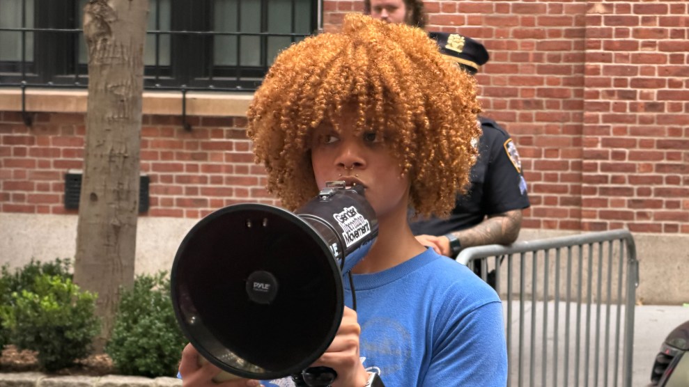 A teen boy holds a megaphone