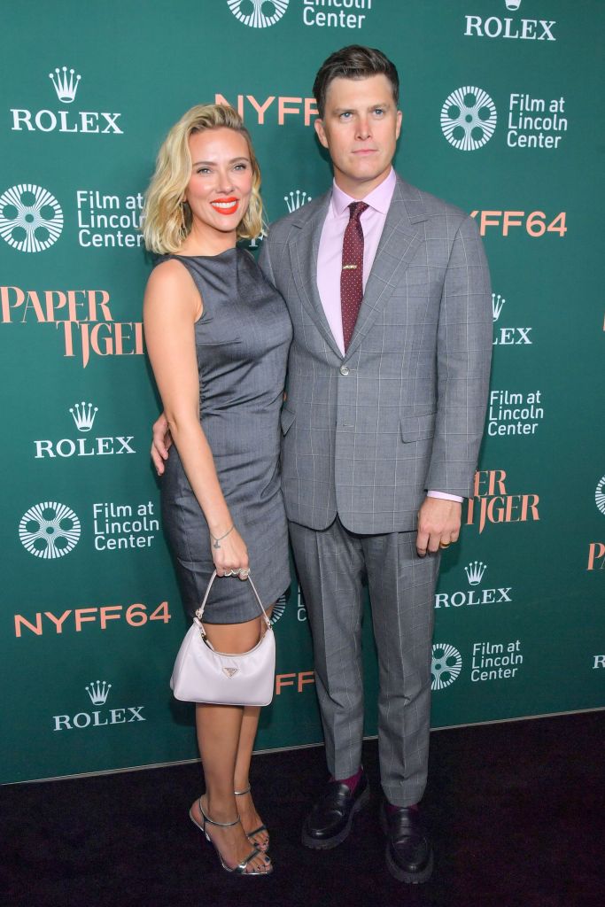 Scarlett Johansson and Colin Jost standing on a green carpet with "Film at Lincoln Center" and "NYFF64" logos behind them.