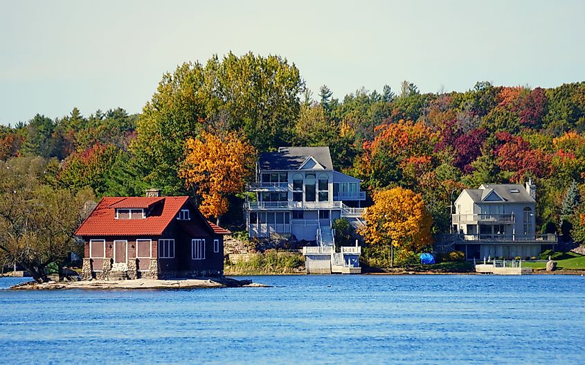 Waterfront homes in Alexandria Bay with fall foliage along the St. Lawrence River