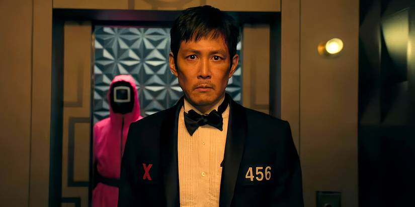 Gi-hun, wearing a tux, enters the Front Man's office in Squid Game.