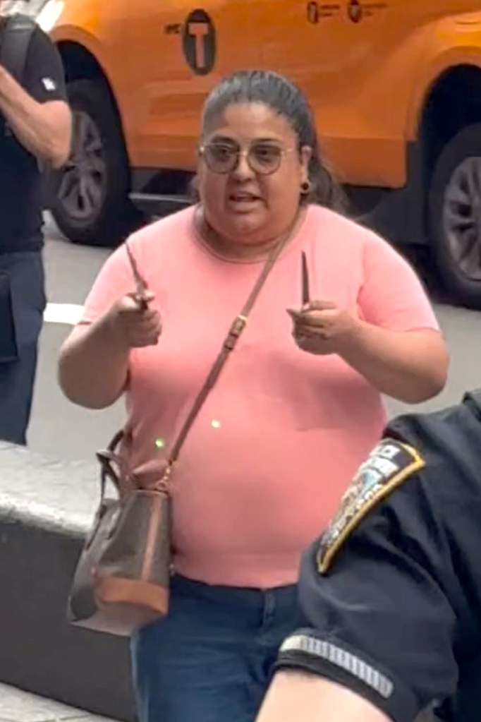 Pamela Cisneros lunging toward police officers while holding knives in each hand.
