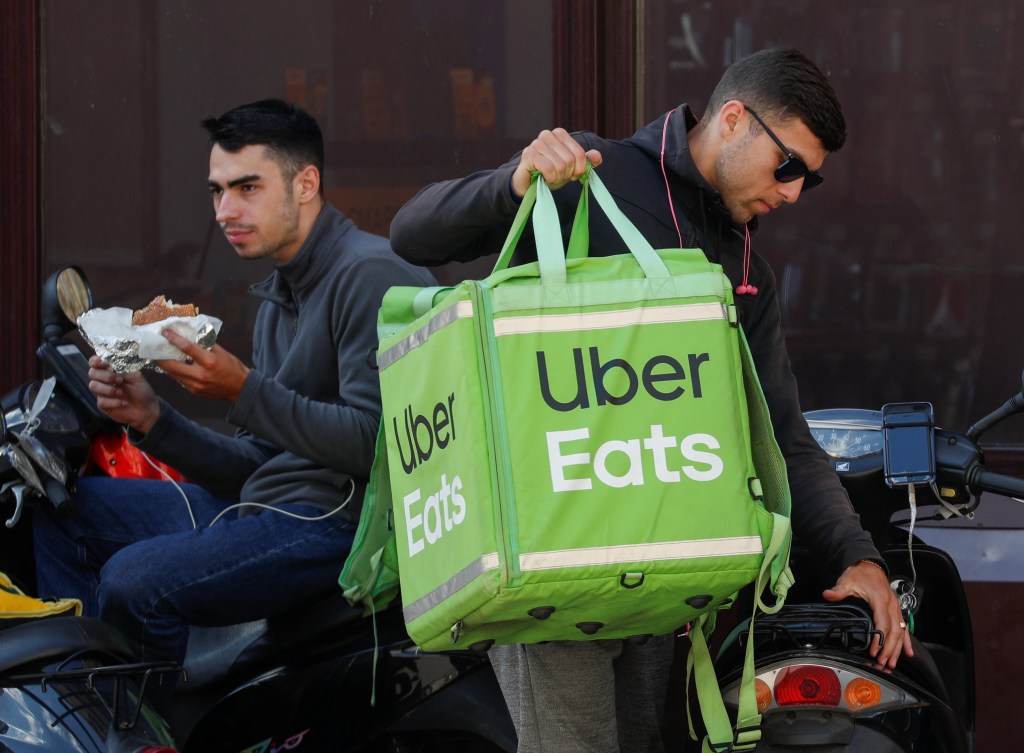 Uber Eats workers wait for orders in central Kiev.