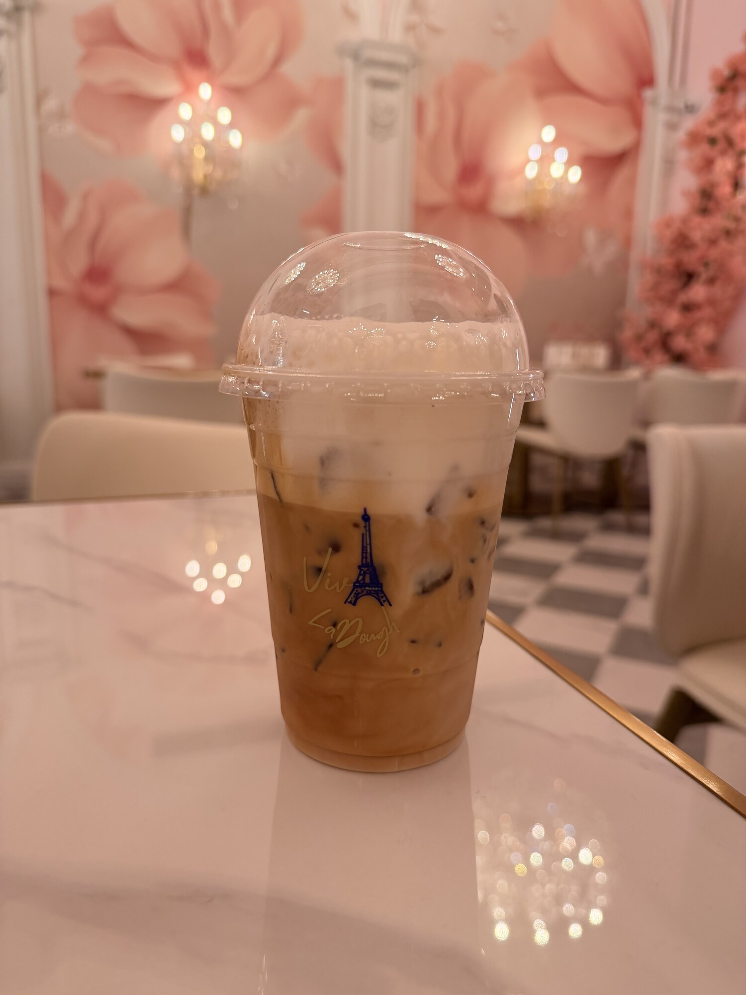 Iced coffee on a marble table at Viva La Dough kosher patisserie Midtown