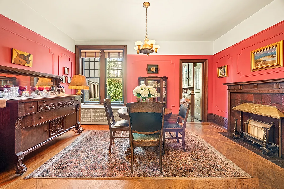 dining room with wood floor, picture rail, wall moldings, mantel