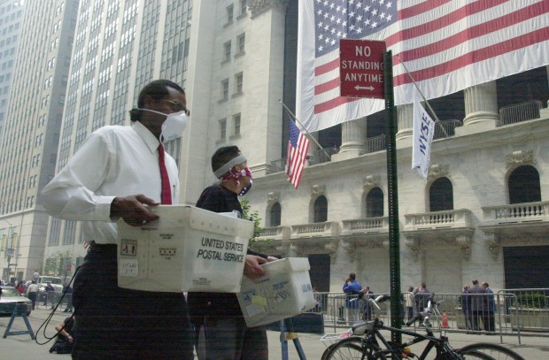 Seven days after the terror attack on the World Trade Center, workers and tourist walk passed the New York Stock Exchange on Sept. 18, 2001. (Todd Maisel / New York Daily News)
