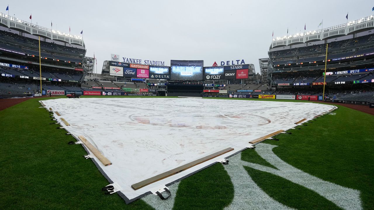 A tarp covers the field during a rain delay at Yankee Stadium in New York. (AP Photo/Seth Wenig)