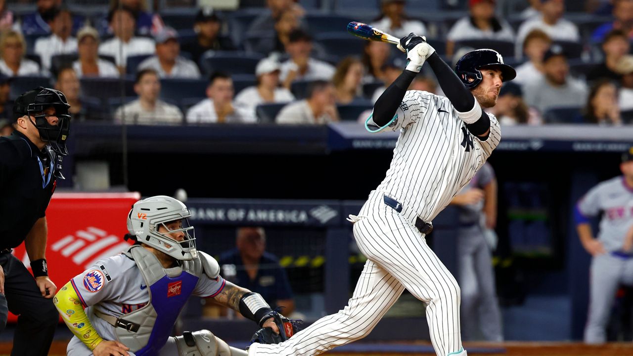 New York Yankees' Cody Bellinger follows through on a three run home run against the New York Mets during the second inning of a baseball game, Friday, Sept. 11, 2026, in New York. (AP Photo/Noah K. Murray)