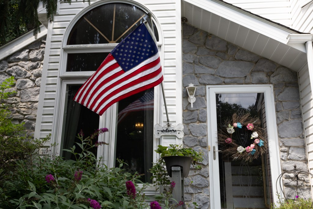 An American flag hung from the front of Alex Gomez's East Stroudsburg, PA home.