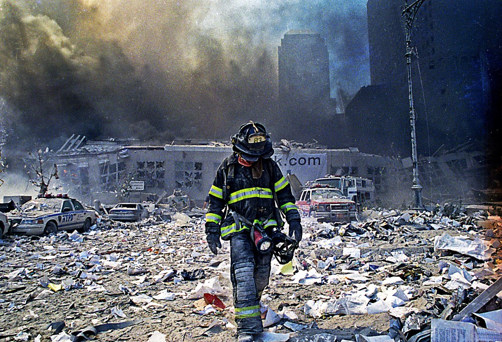 firefighter walks through rubble from WTC attacks
