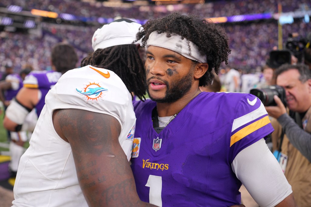 Minnesota Vikings quarterback Kyler Murray greets Miami Dolphins quarterback Malik Willis on the field after a game.