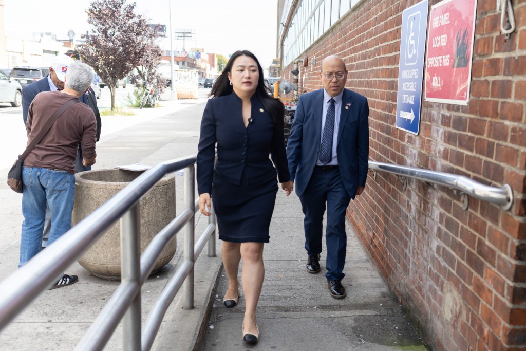 Queens Councilmembers Julie Won, left, and Phil Wong prepare to enter a Long Island City veterans shelter