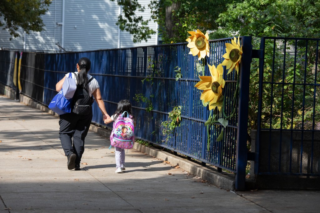 Caregivers walk students from a public school in Brooklyn