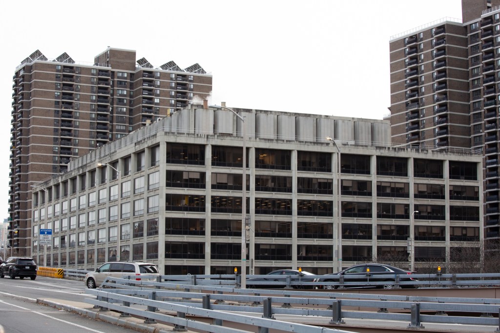 The concrete brutalist office building at 100 Gold Street was visible from the Brooklyn Bridge overpass