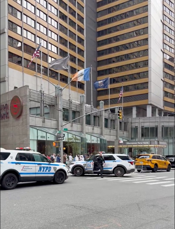 NYPD vehicles and officers responding to a shooting at 52nd and 7th Avenue outside the Sheraton New York.