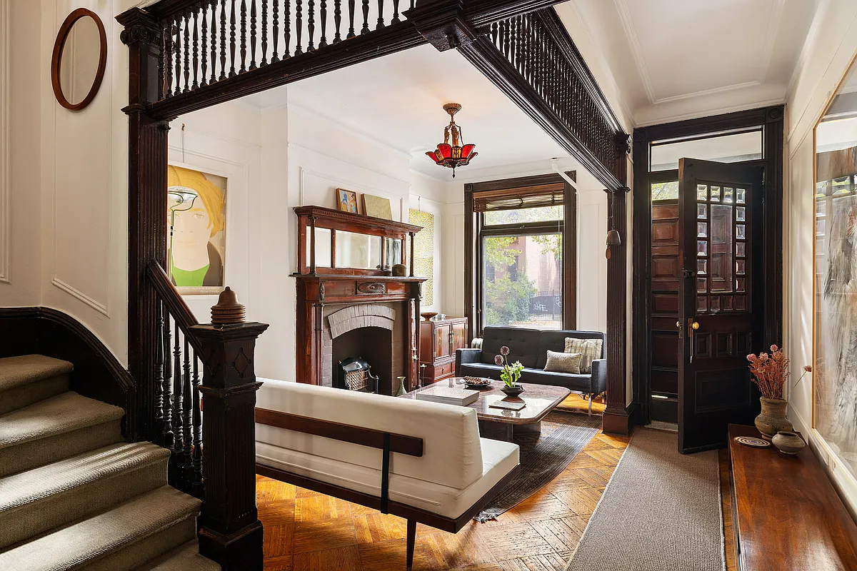 parlor with fretwork, mantel, stair