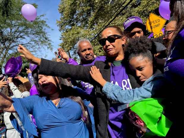 Nathaly Ramirez's mother, Nathaly (in sunglasses), is pictured with family members during a vigil outside her daughter's apartment building on Olinville Ave. in the Bronx on Saturday, Oct. 10, 2026. (Rebecca White / New York Daily News)