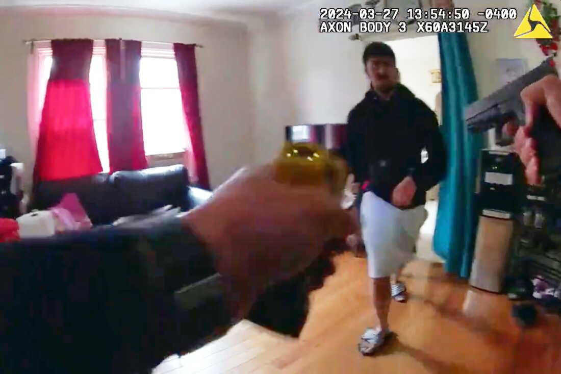 This image made from New York Police Department body camera footage released by the New York Attorney General's Office shows an officer pointing his gun at Win Rozario in Rozario's family home on March 27, 2025, in the Queens borough of New York.