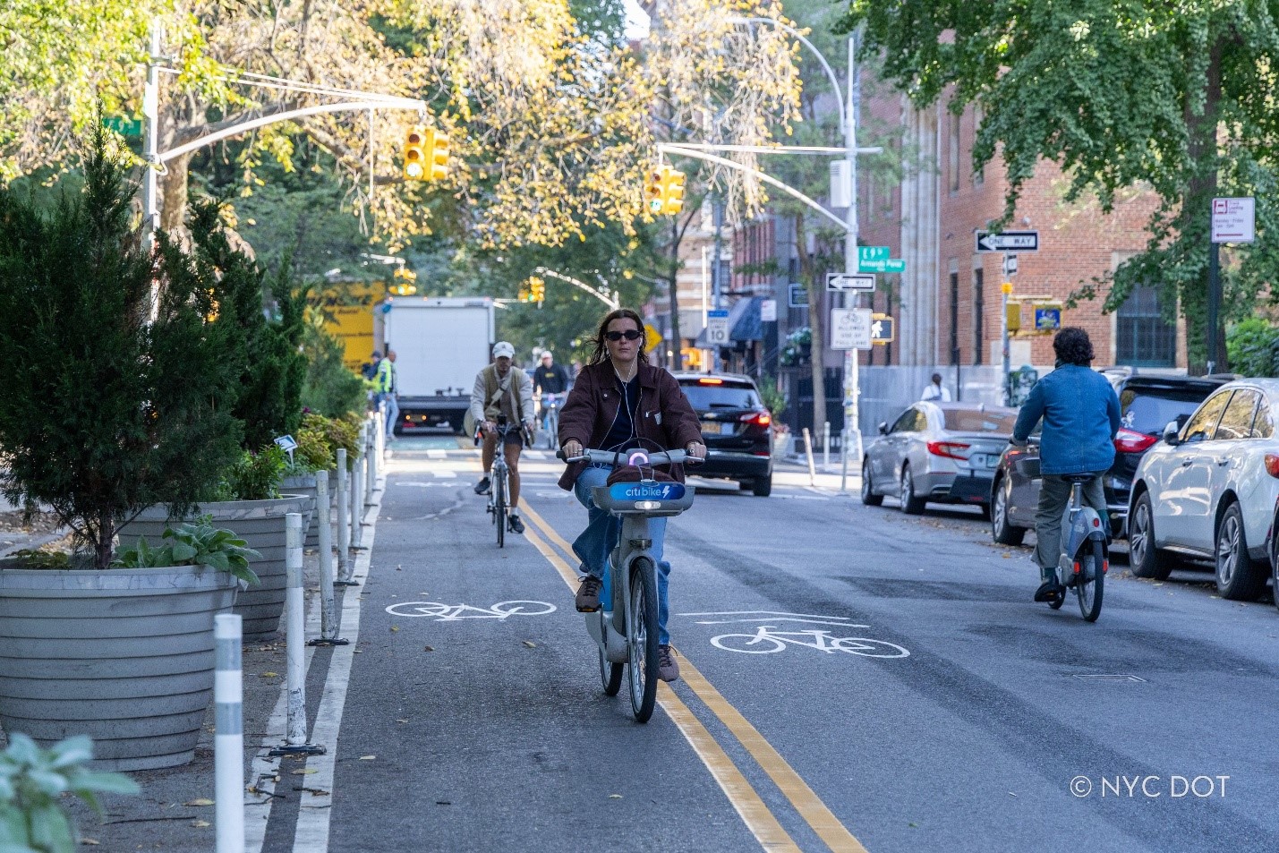 Cyclists and vehicles traveling along the redesigned Avenue B in the East Village, Manhattan. Credit: NYC DOT