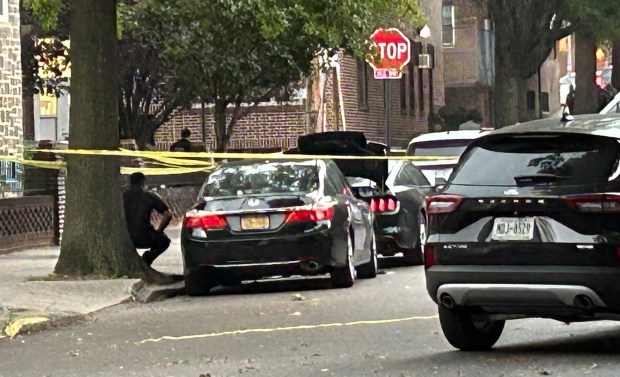 Police investigate after an off-duty NYPD detective was stabbed and wounded during an attempted robbery near his car parked black Mustang (trunk open) at E. 208th St. and Stueben Ave. in the Bronx on Friday, Oct. 2, 2026. (Kerry Burke / New York Daily News)