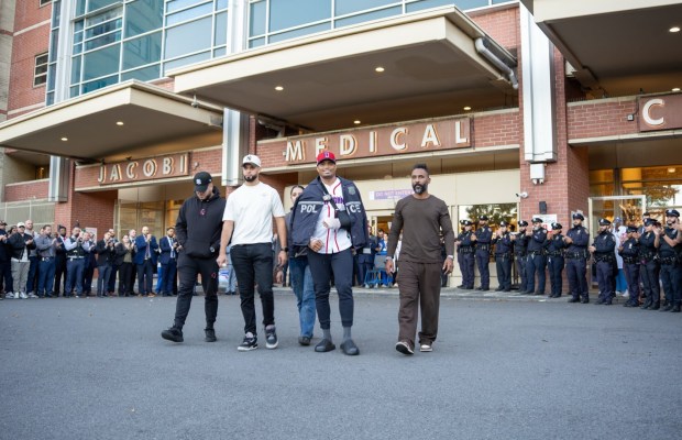 NYPD officers and brass cheer Monday as Det. Jose Mercedes, who was repeatedly stabbed during an attempted robbery in the Bronx while off-duty, was released from Jacobi Medical Center. (NYPD)