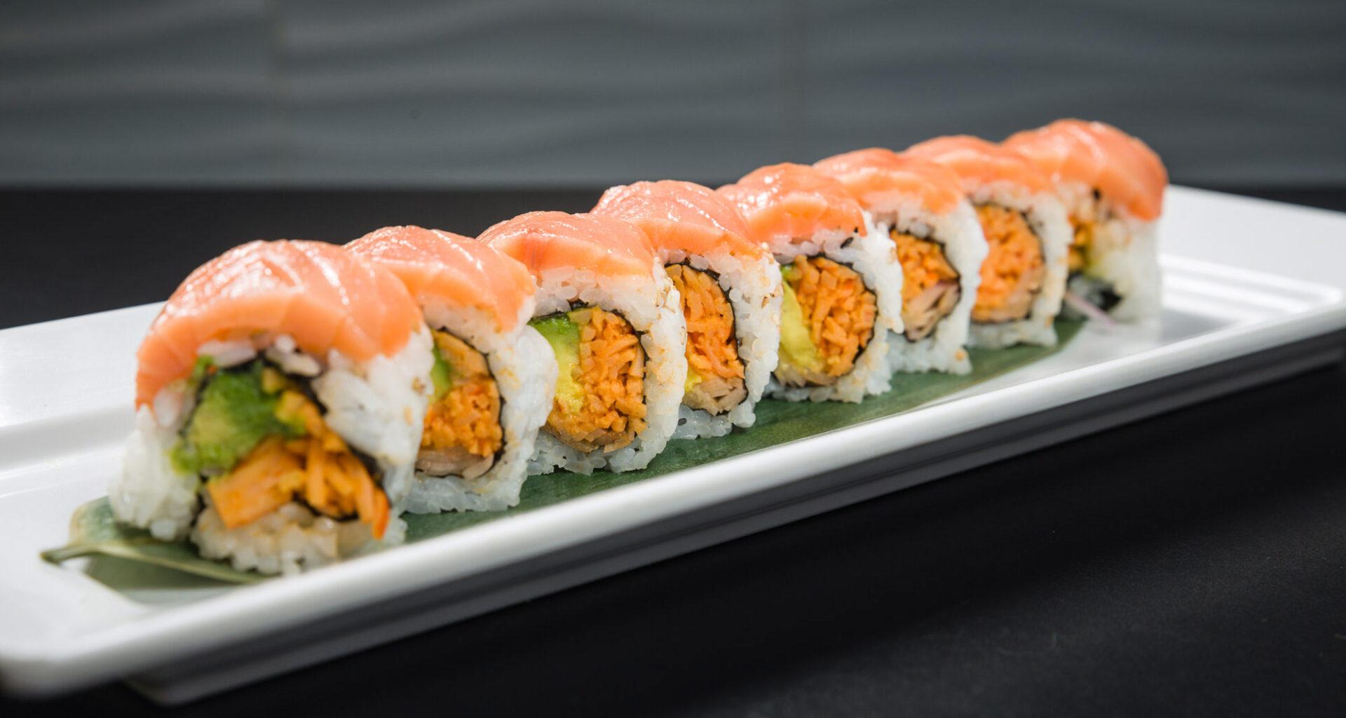 Salmon-topped sushi roll platter at Noribar kosher sushi restaurant