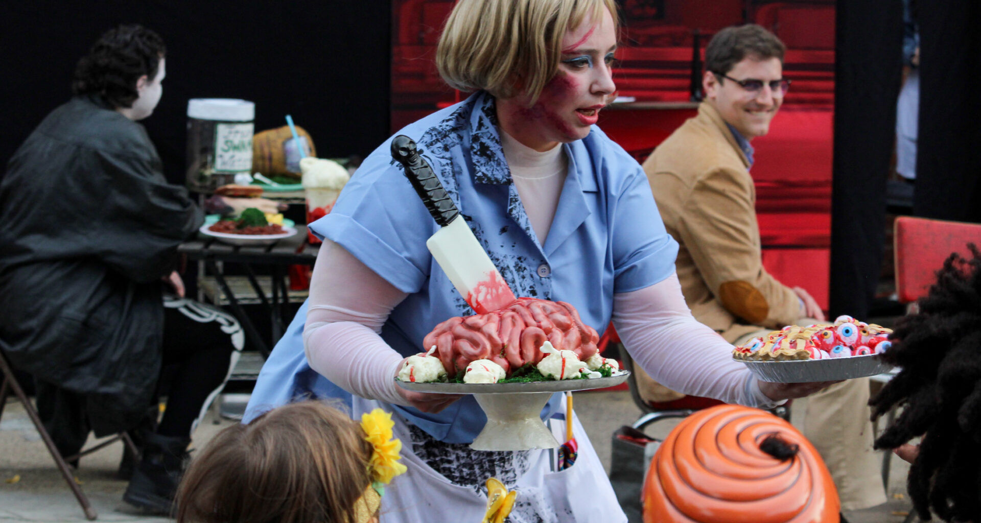 halloween - costumed actor holding fake food