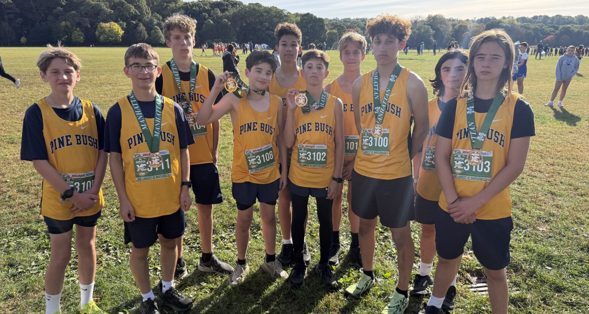 kids in track & field uniforms standing for picture