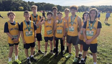 kids in track & field uniforms standing for picture