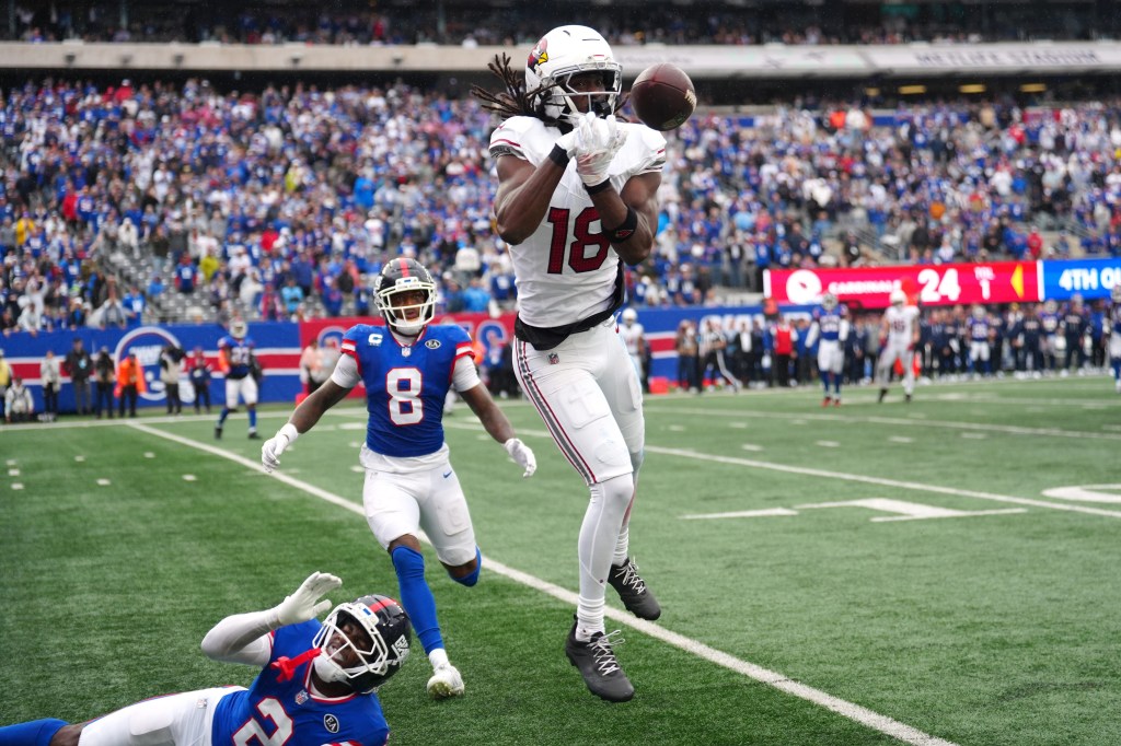 Arizona Cardinals wide receiver Marvin Harrison Jr. misses a pass as a Giants player falls to the turf.