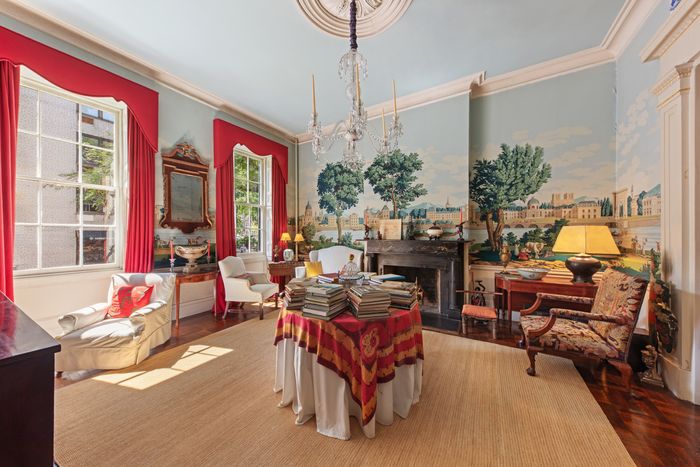 A 1970s reproduction of 1814 wallpaper, showing the monuments of Paris, extends across most of the parlor level.