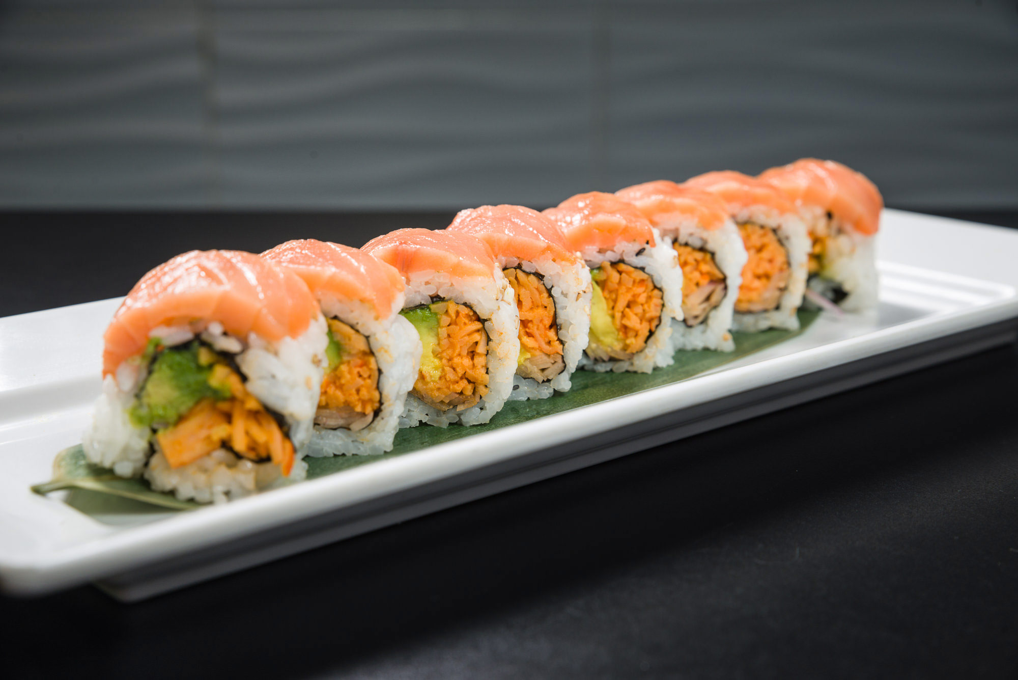 Salmon-topped sushi roll platter at Noribar kosher sushi restaurant