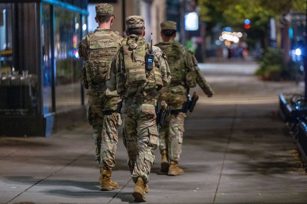 National Guard members patrol a street at night in Washington, D.C.